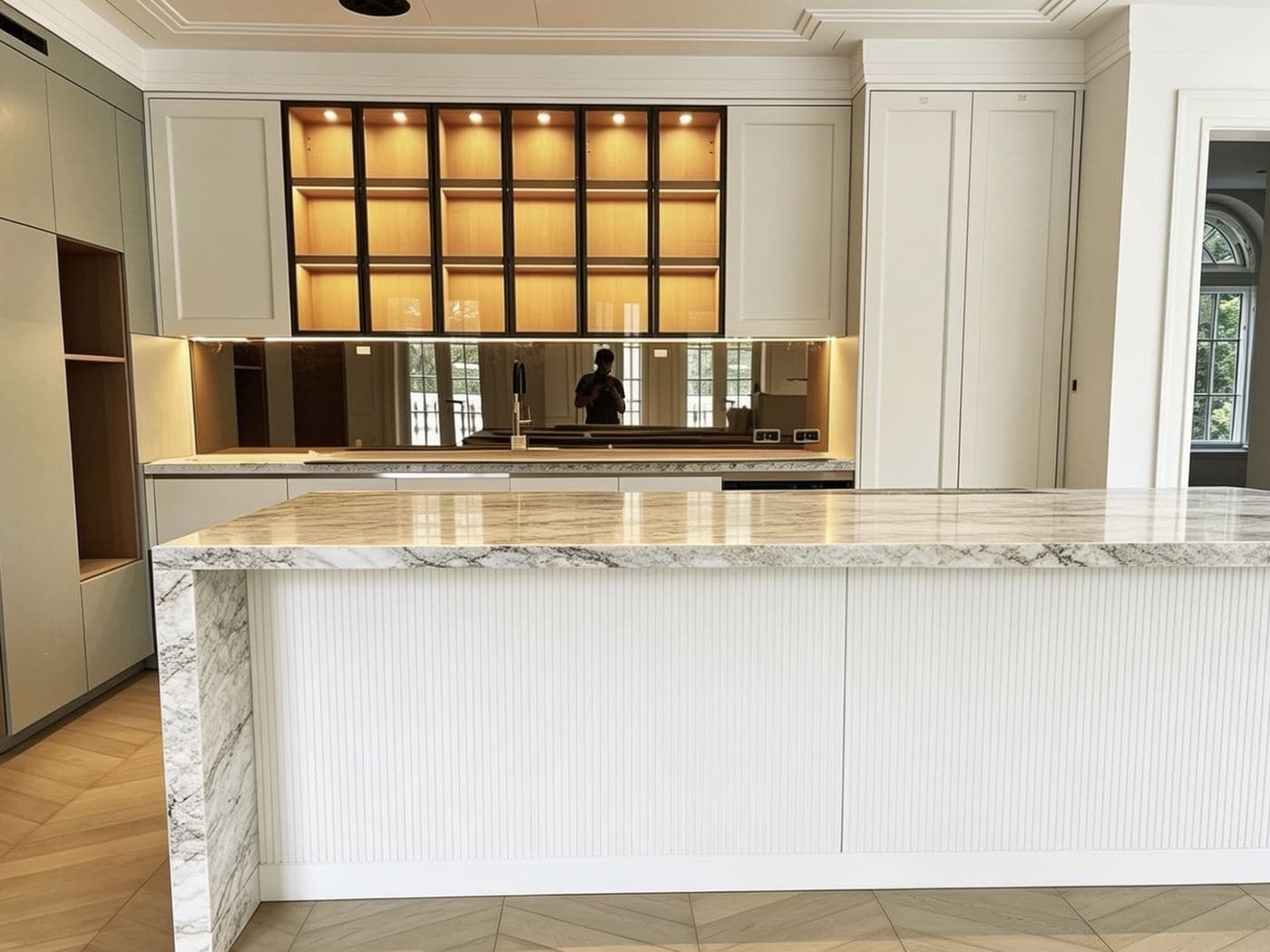 Bespoke kitchen with marble island and backlit display cabinetry