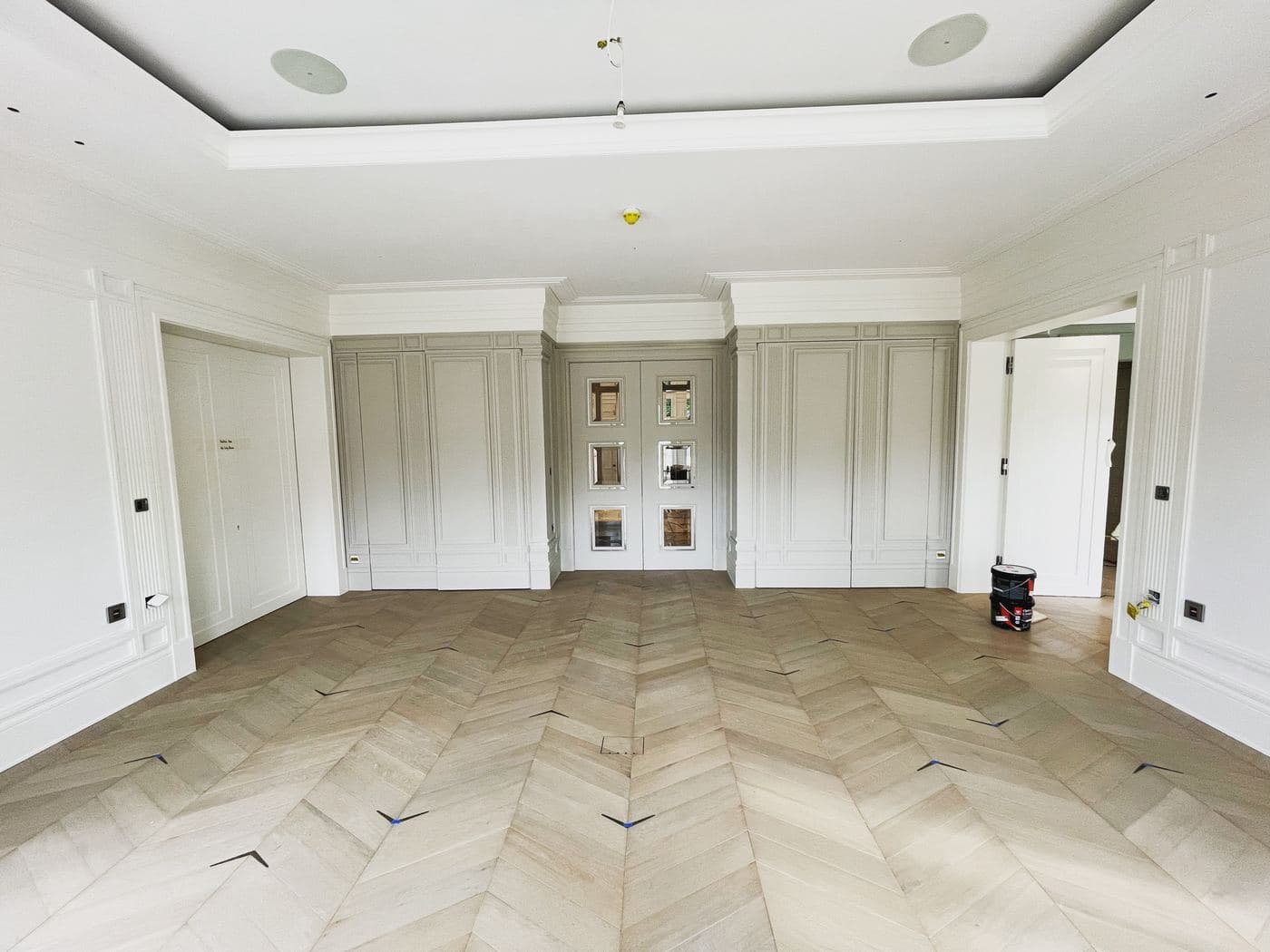 Decorated panelled reception room with chevron parquet