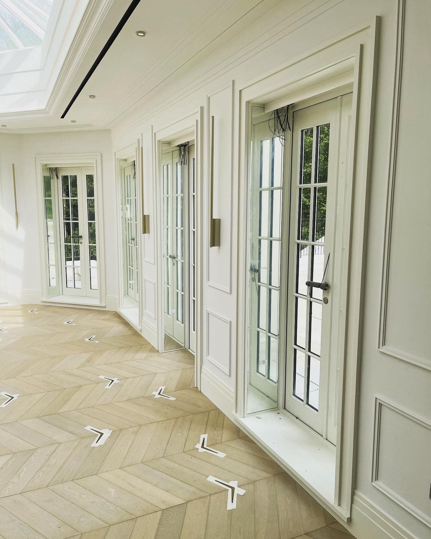 Roof lantern hallway with panelling and chevron parquet
