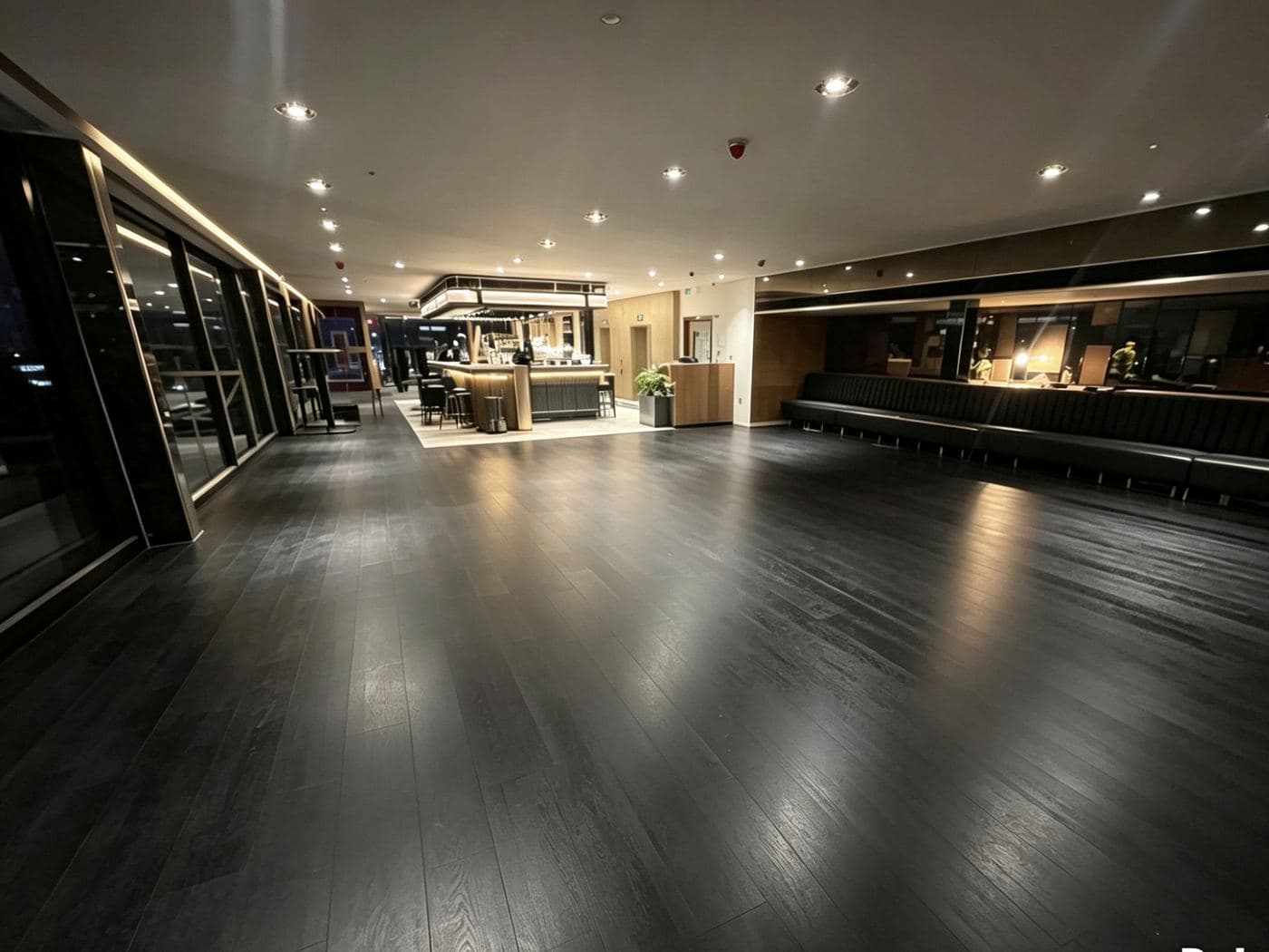 Commercial venue fit-out by Avex with dark timber flooring and bespoke bar counters